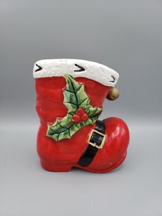 a ceramic christmas boot with holly berry decoration