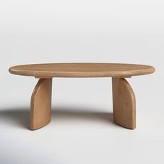 an oval wooden table with curved legs and a circular top, on a white background