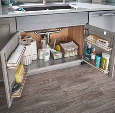 an open cabinet in the middle of a kitchen