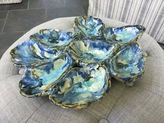 a bunch of blue bowls sitting on top of a chair