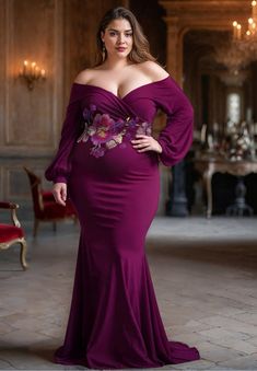 a woman in a purple dress posing for the camera with her hands on her hips