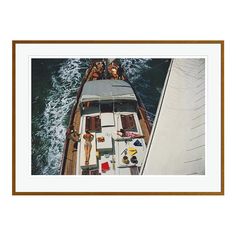 an overhead view of a boat in the water with people on it's deck