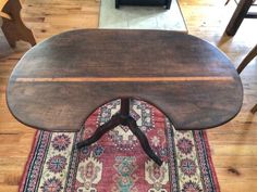 a wooden table sitting on top of a rug