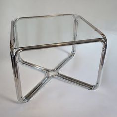 a glass and chrome coffee table on white background