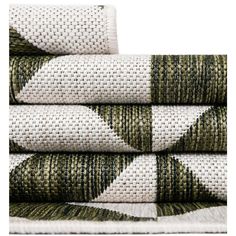 four green and white rugs stacked on top of each other