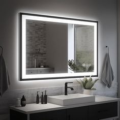 a bathroom with a sink, mirror and towel hanging on the wall next to it