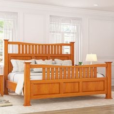 a wooden bed sitting in a bedroom on top of a hard wood floor next to a window