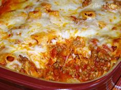 a casserole dish with meat, cheese and sauce