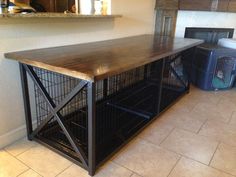 a dog cage is sitting on top of a table in the middle of a room