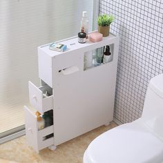 a bathroom with a toilet and a white cabinet