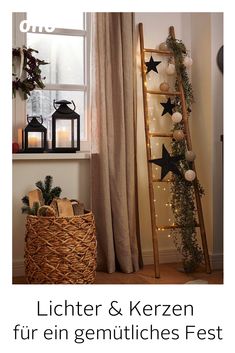 a basket with christmas decorations and candles in front of a window next to a ladder