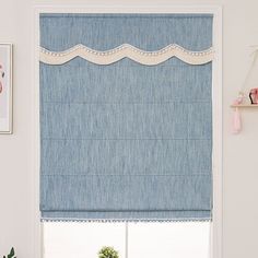 a blue roman blind in a white room