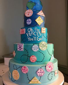 a three tiered cake with stickers on the top and around it's edges