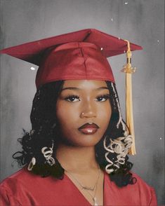 a woman wearing a red graduation cap and gown with a tassel on her head