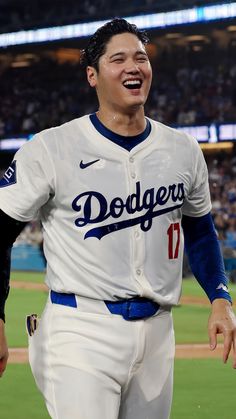 a baseball player is laughing while standing on the field