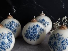 four blue and white ornaments sitting on top of a table