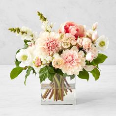 a vase filled with pink and white flowers