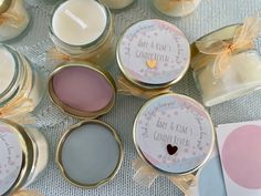 several small jars filled with candles on top of a table