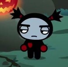 a cartoon character with an evil look on his face and ears, standing in front of a pumpkin