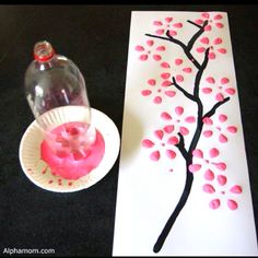 a paper plate with pink icing on it next to a painting and a vase