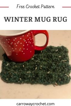 a coffee cup sitting on top of a green rug next to a red mug holder