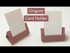 an origami card holder is shown with two cards in it and the other one has