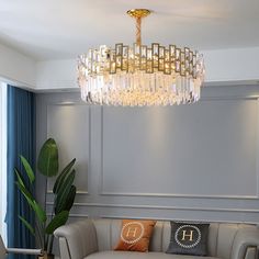 a living room filled with furniture and a large chandelier hanging from the ceiling