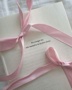 an open book with pink ribbon tied around it and the words for younger me, who would be his first choice