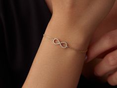 🌟 14K Gold Infinity Bracelet 🌟 Celebrate endless love and connection with our 14K Gold Infinity Bracelet. This elegant piece symbolizes eternity and the unbreakable bonds we cherish. The delicate infinity symbol shines brightly on your wrist, adding a touch of timeless beauty to any outfit. ✨ Available in three stunning colors--classic yellow gold, warm rose gold, and sleek white gold--this bracelet can be customized to reflect your unique style. With lengths ranging from 6 inches to 8.5 inche Sleek Bracelet For Women, Yellow Gold Infinity Bracelets For Everyday, Yellow Gold Infinity Bracelet For Everyday, Dainty Infinity Yellow Gold Bracelets, Dainty Yellow Gold Infinity Bracelet, 14k Gold Infinity Bracelet For Anniversary, 14k Gold Infinity Bracelet Gift, Minimal Gold Bracelet, Infinity Bracelet Gold