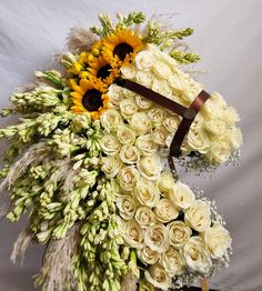 a bouquet of sunflowers and white roses