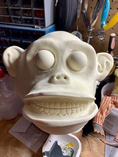 a fake monkey head sitting on top of a table