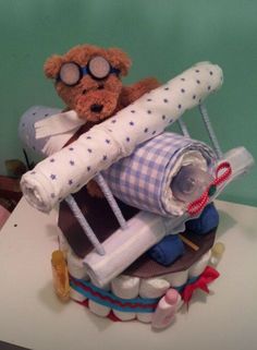 a teddy bear sitting on top of a pile of rolled up papers and other items