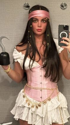 a woman in a pink corset and headband is holding an umbrella while taking a selfie