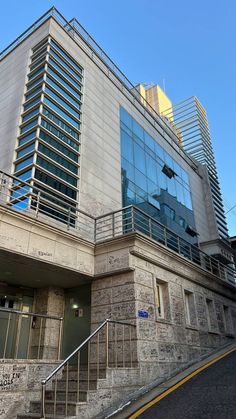 the building has many windows and balconies on it's sides, along with some stairs