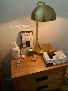 a table with a lamp, books and other items on it