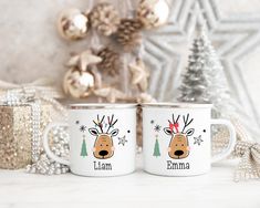 two white coffee mugs with reindeer faces on them and the words lamaa in red