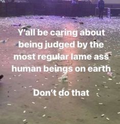 two people are standing in the sand with garbage all over them and one person is holding a cell phone