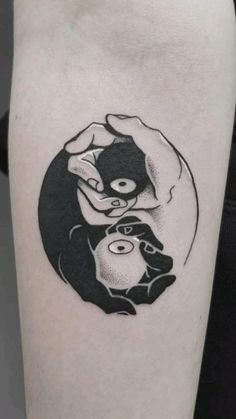 a woman's arm with a black and white tattoo on it