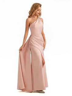 a woman in a long pink dress with one shoulder and slited skirt, posing for the