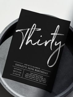 a black and white birthday party card with the word thirty printed in cursive font