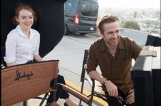 a man and woman sitting in chairs on the street