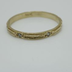 a gold ring with three diamonds on it