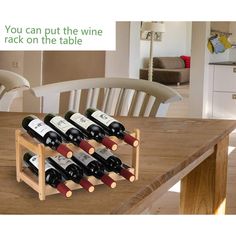 a wooden wine rack filled with bottles on top of a table