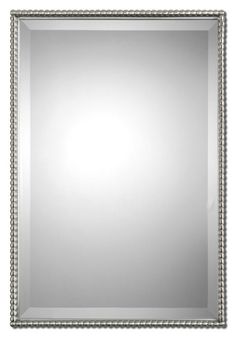 a silver framed mirror with beaded trim around the edges and an ornate border on the edge