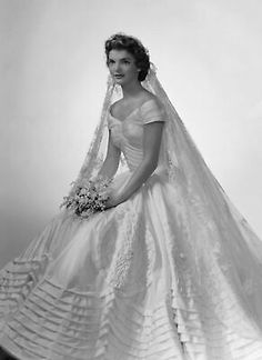 an old photo of a woman in a wedding dress