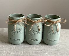 three mason jars tied with twine and labeled ball masons are sitting on a table