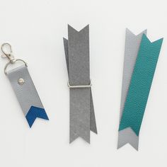 three pieces of leather with different colors and shapes are shown next to each other on a white surface