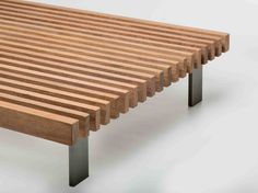 a wooden bench with metal legs and slats on the top, against a white background