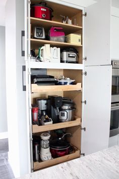 an open cabinet with many items in it