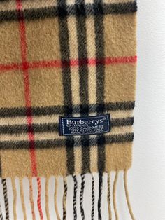 Description : Vintage Burberry scarf. 100% cashmere. Traditional Burberry nova check plaid in tan/red/black/white. Small moth hole - price reflects Item Number : P28 Category : Scarf Brand : Burberry Burberry Inspired Scarf, Burnerry Cotton Scarf, Burberry Scarves & Shawls, Burberry Vintage Scarf, Disneyland Sweatshirt, Small Moths, Burberry Plaid, Burberry Classic, Burberry Scarf